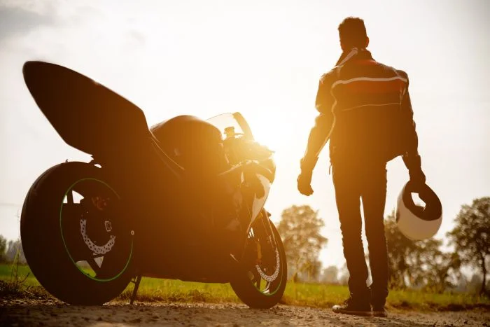 Motorbike rider looking into sunset