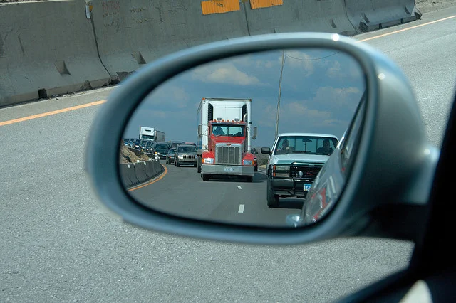 truck in rearview mirror highway
